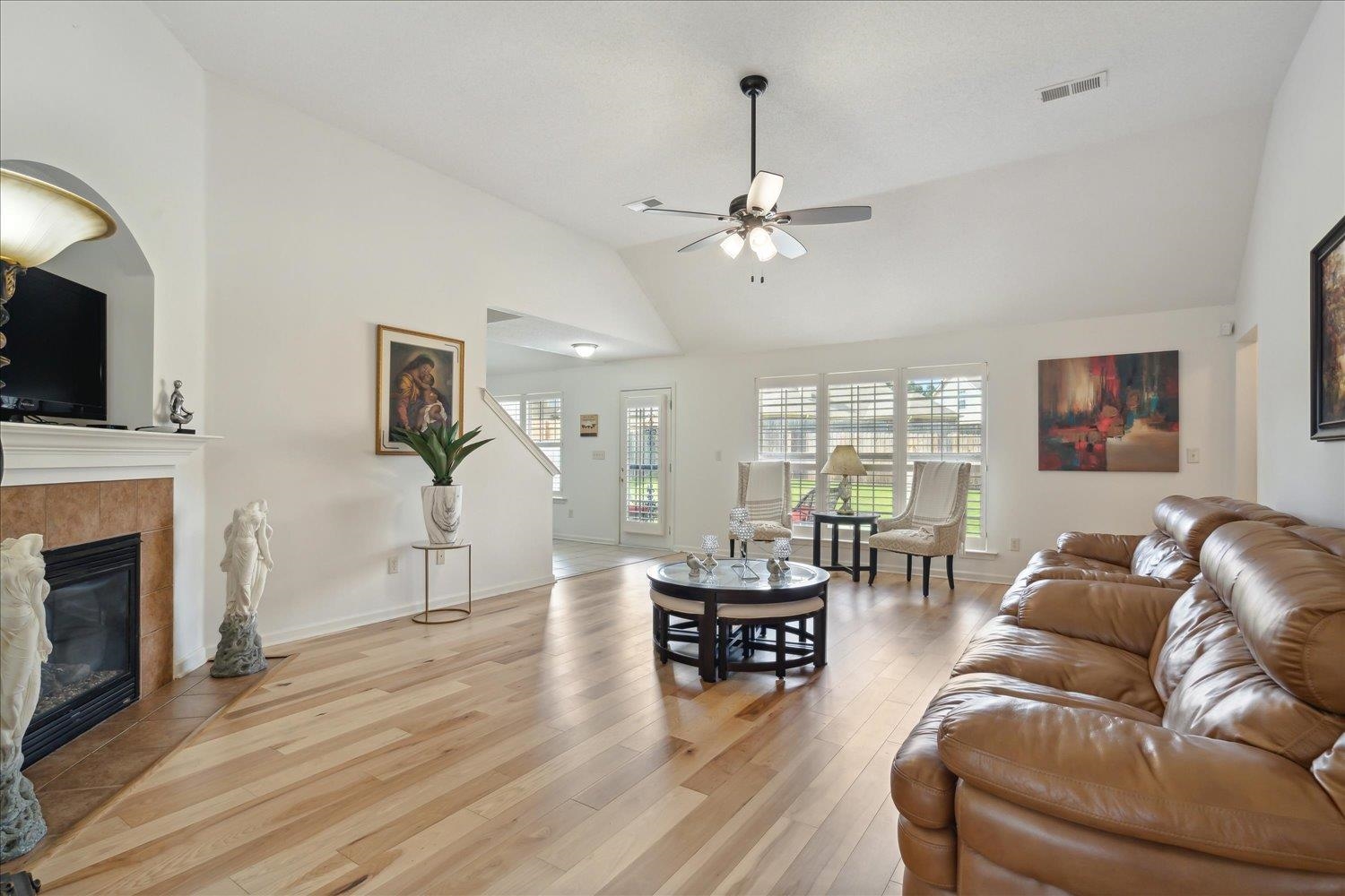 7464 Britt Way Memphis, TN 38125 - Photo 9 of 29 a living room with furniture a fireplace and a flat screen tv