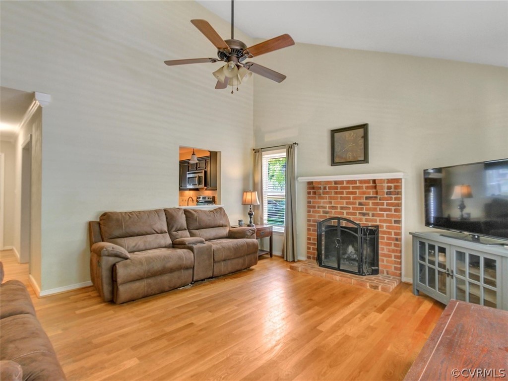 5509 Chatmoss Road Midlothian, VA 23112 - Photo 12 of 38 a living room with furniture a flat screen tv and a fireplace