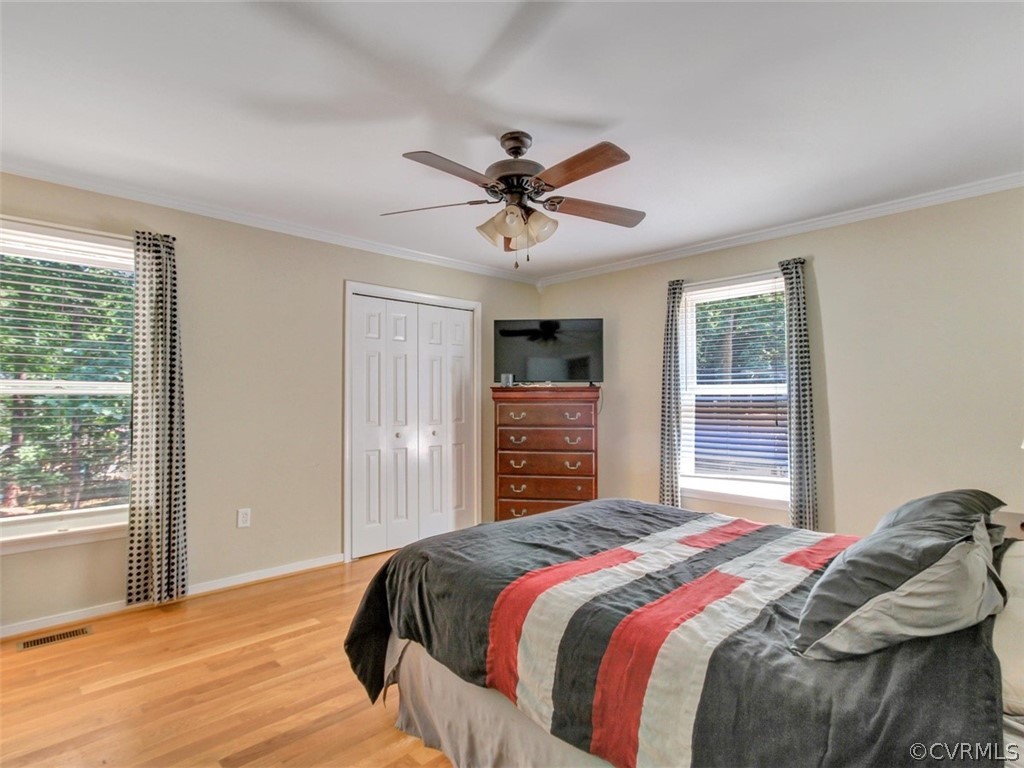 5509 Chatmoss Road Midlothian, VA 23112 - Photo 18 of 38 a bedroom with a large bed and a chandelier