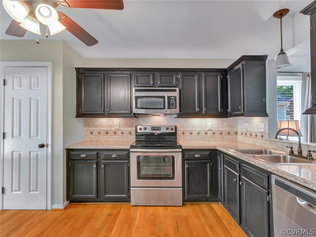 5509 Chatmoss Road Midlothian, VA 23112 - Photo 5 of 38 a kitchen with stainless steel appliances granite countertop a sink and stove top oven