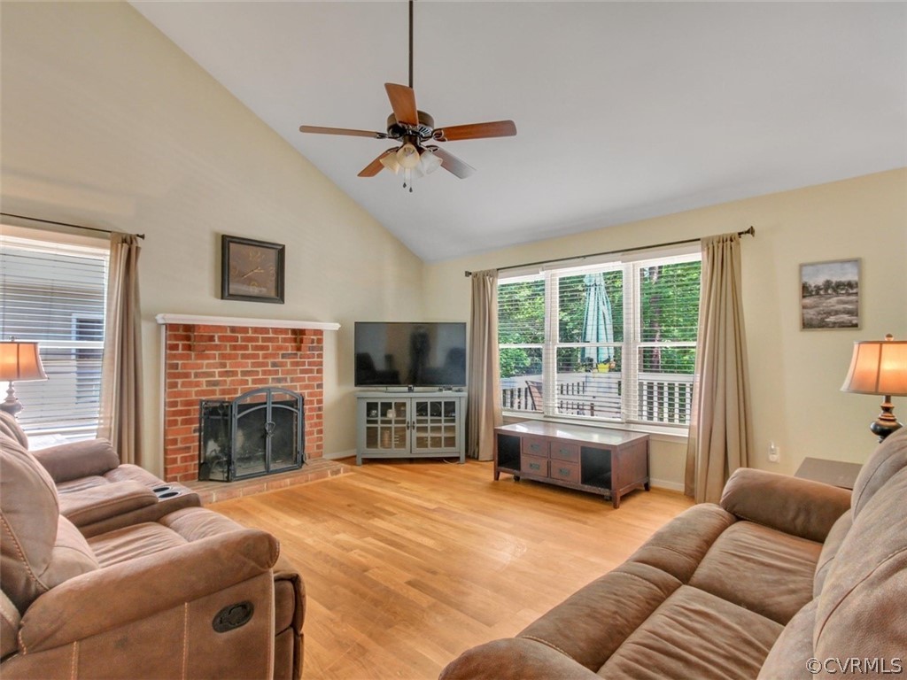 5509 Chatmoss Road Midlothian, VA 23112 - Photo 10 of 38 a living room with furniture a fireplace and a flat screen tv