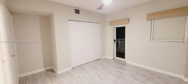 an empty room with wooden floor