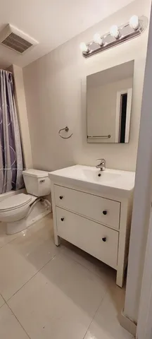 a bathroom with a white bath tub and a shower