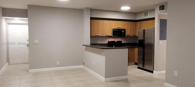 a kitchen with a refrigerator and a sink