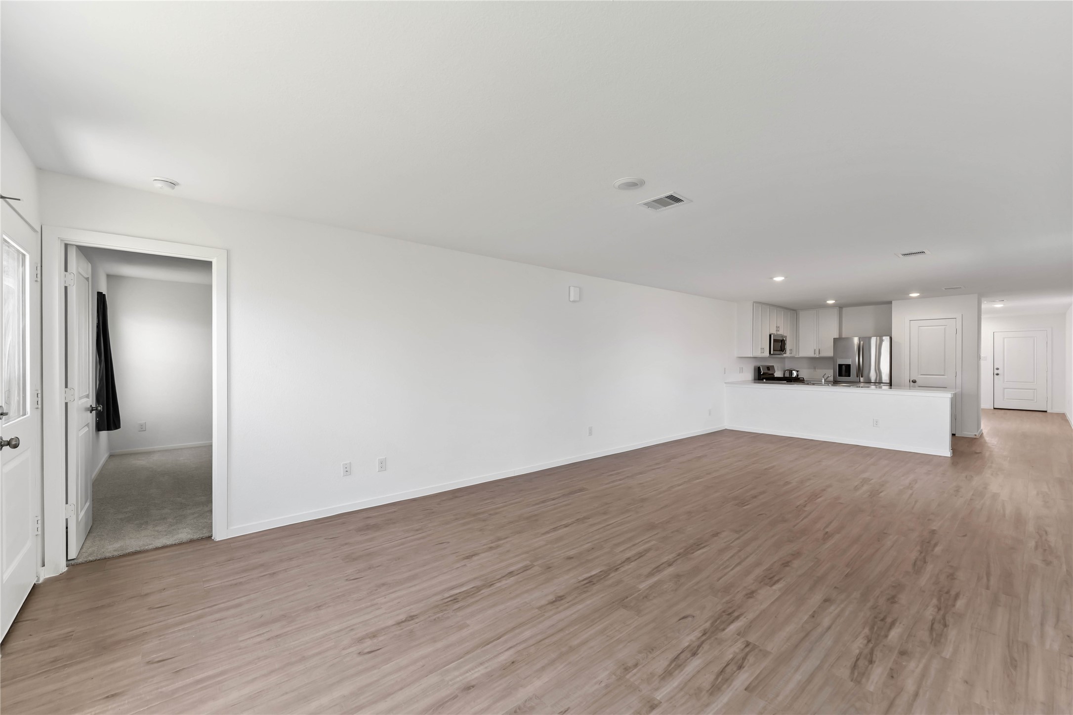 21002 Longwitton Lane Humble, TX 77338 - Photo 11 of 26 a view of a kitchen with wooden floor and a sink
