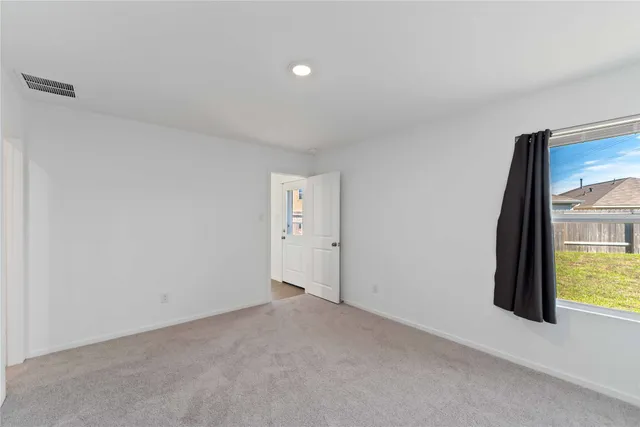 a view of an empty room and a window