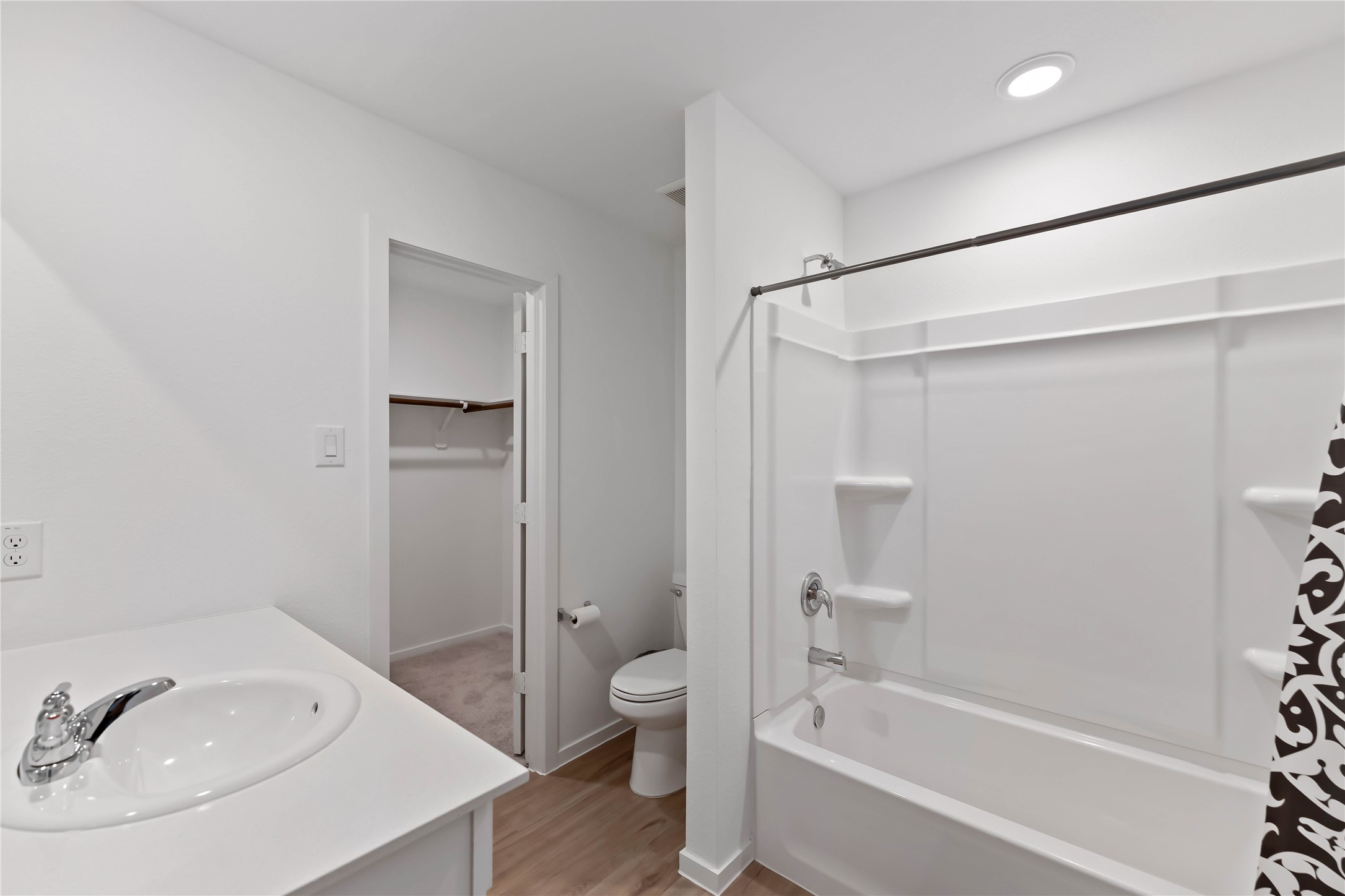 21002 Longwitton Lane Humble, TX 77338 - Photo 14 of 26 a bathroom with a tub shower sink vanity and toilet