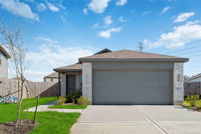 a front view of a house with a garden and plants