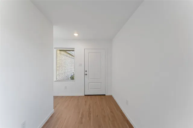 a view of a hallway with wooden floor