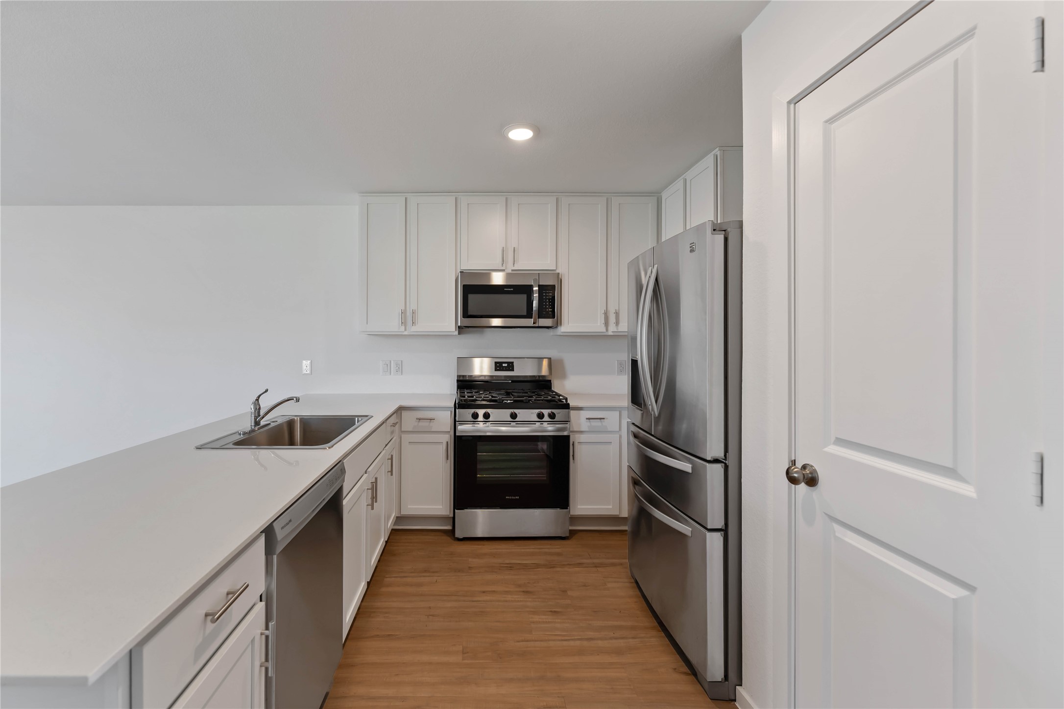 21002 Longwitton Lane Humble, TX 77338 - Photo 6 of 26 a kitchen with stainless steel appliances granite countertop a refrigerator stove and sink