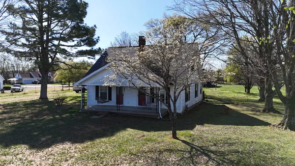 a view of a house with a yard covered with snow in the background