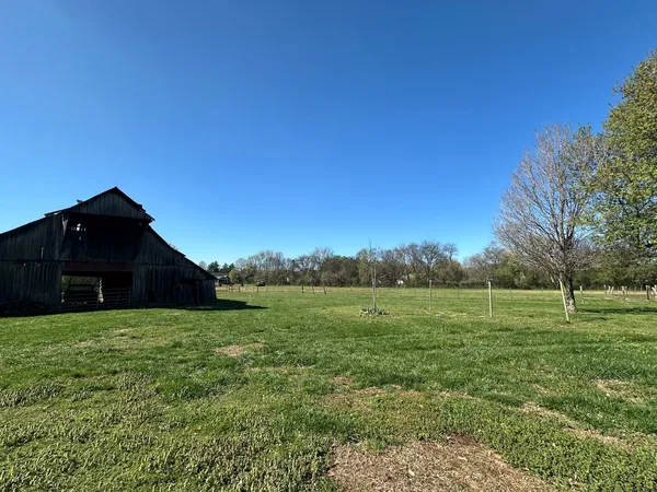 a view of a big yard with a house
