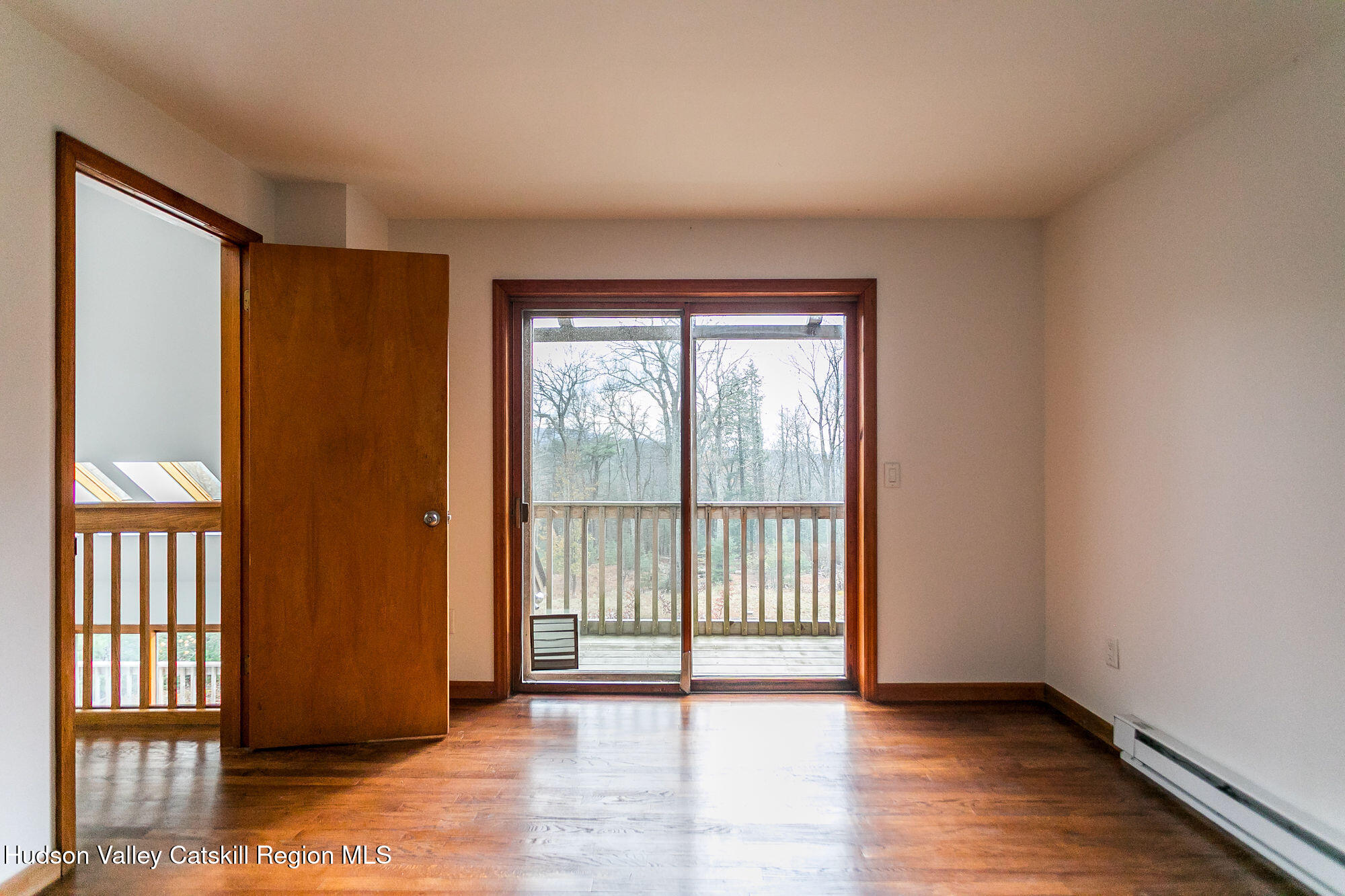 446 Abbey Road Woodstock, NY 12457 - Photo 24 of 32 a view of an empty room with wooden floor and a window