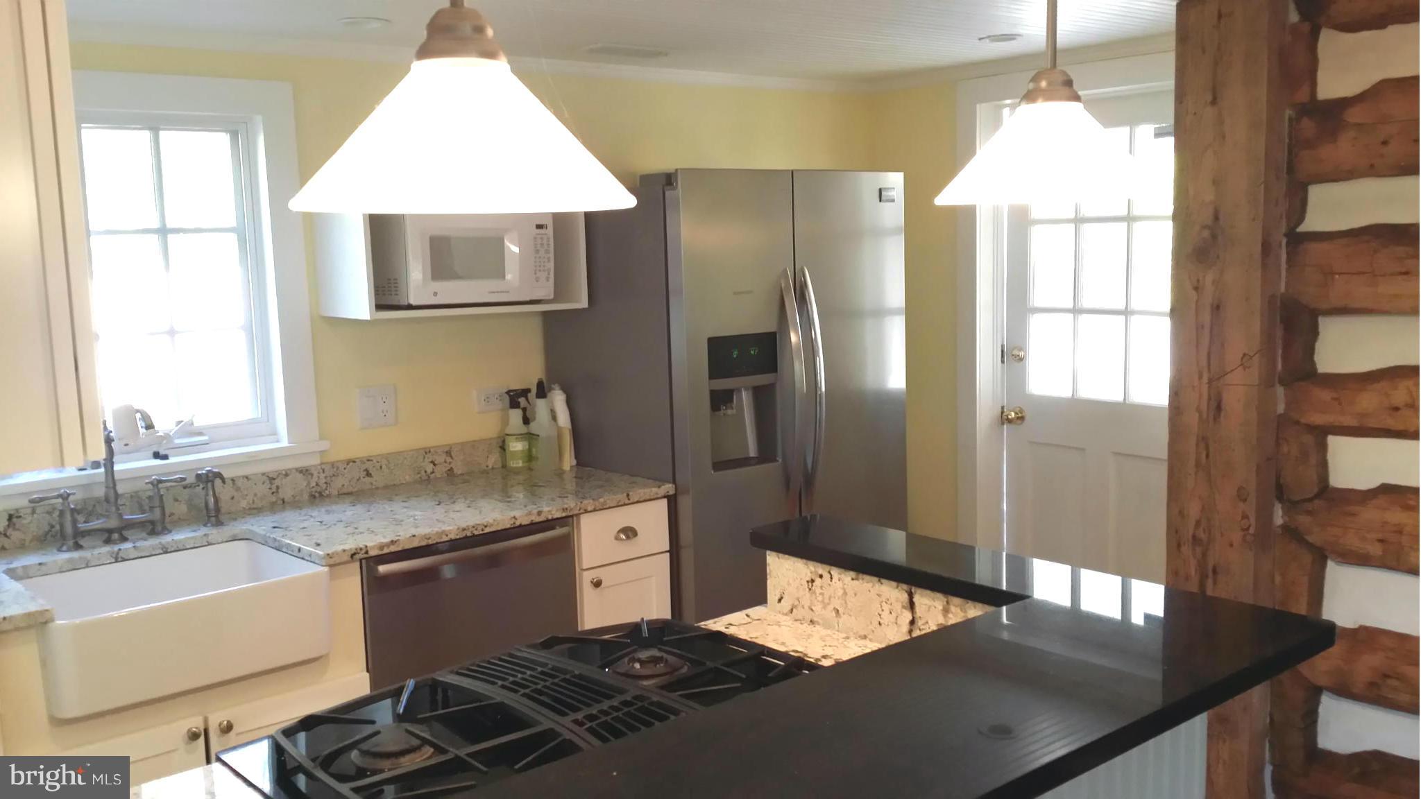 1550 Bishop Meade Road Boyce, VA 22620 - Photo 12 of 24 a kitchen with stainless steel appliances granite countertop a sink stove and refrigerator
