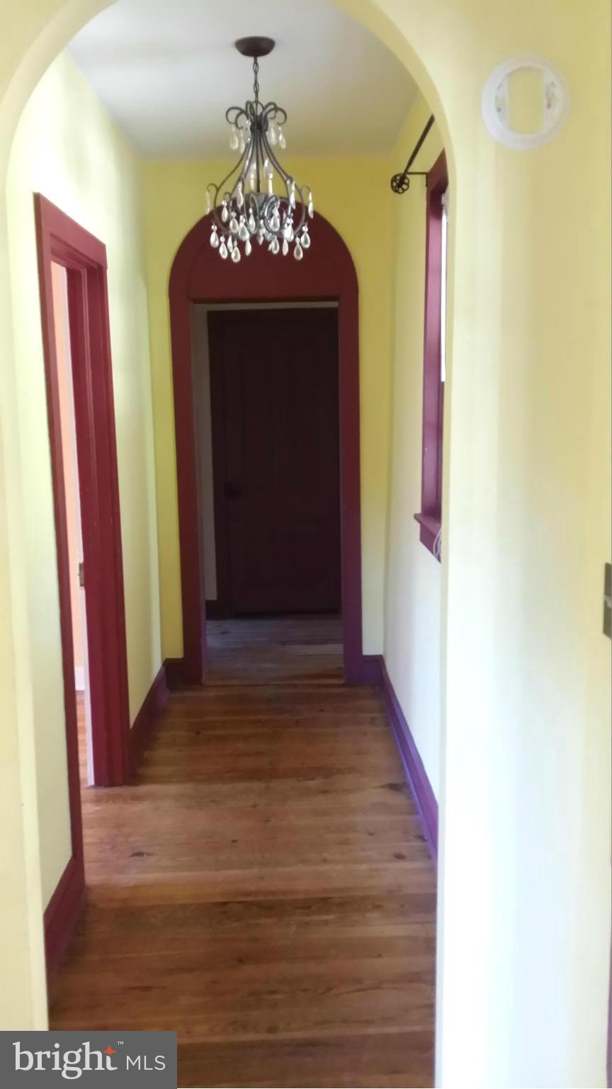 1550 Bishop Meade Road Boyce, VA 22620 - Photo 18 of 24 a view of a hallway with a chandelier