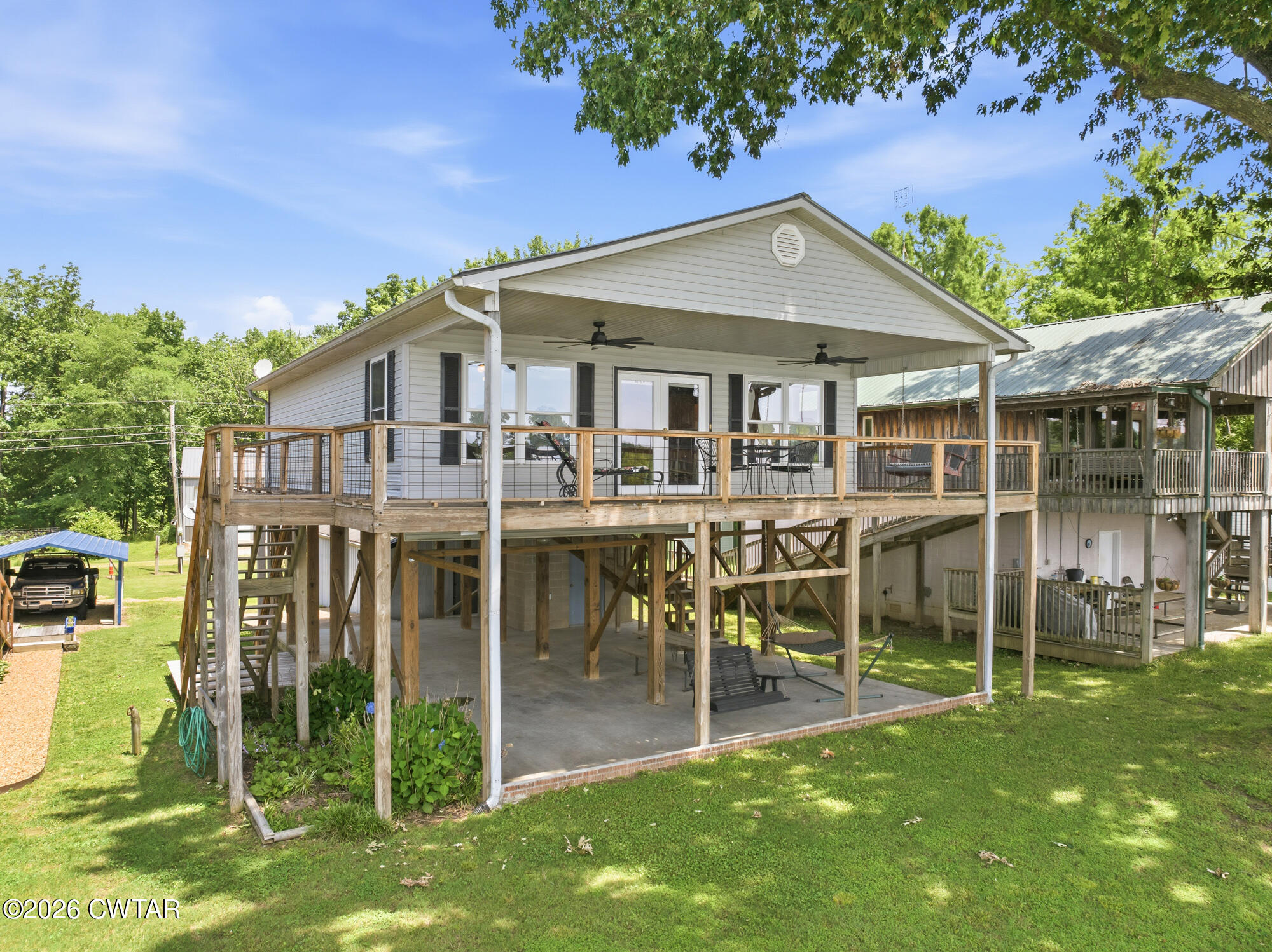 1728 Yarbro Landing Lane Decaturville, TN 38329 - Photo 18 of 44 a front view of a house with a yard table and chairs