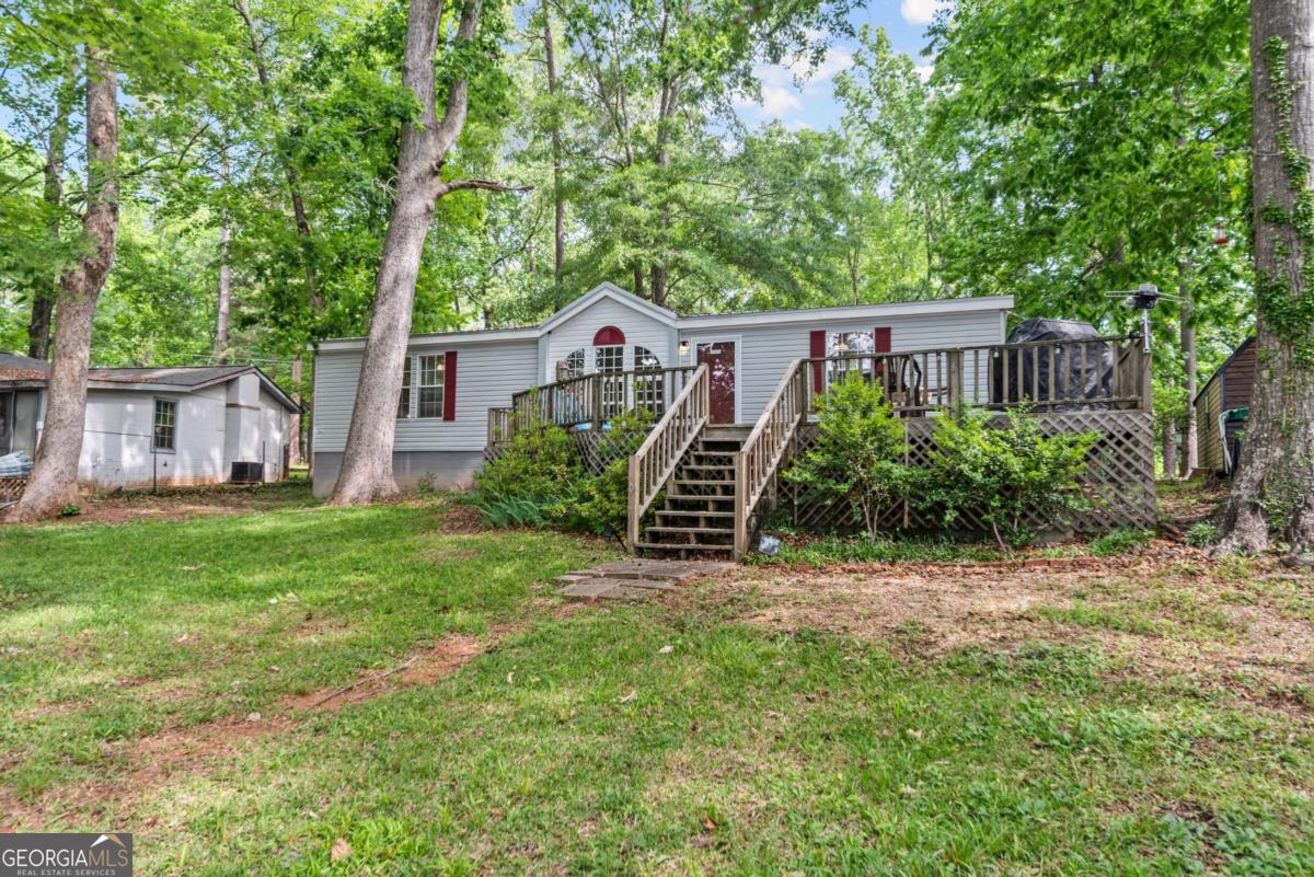 194 Phillips Road Eatonton, GA 31024 - Photo 52 of 57 a view of a house with backyard and a tree