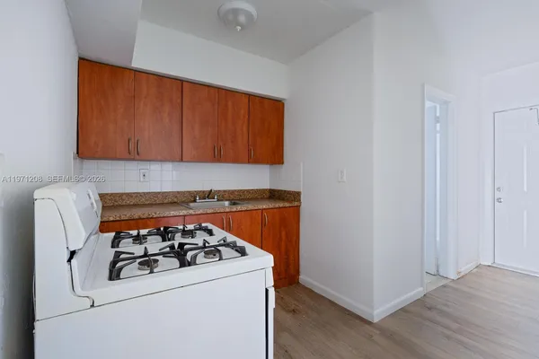 a white stove top oven sitting inside of a kitchen