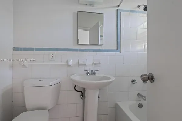 a bathroom with a sink toilet and mirror