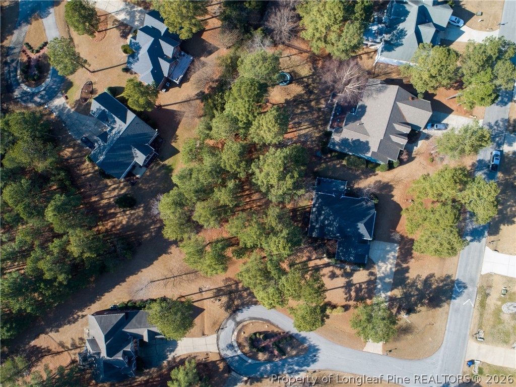 an aerial view of a house with a yard and outdoor seating