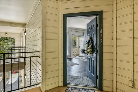 a view of a porch with a glass door and a porch