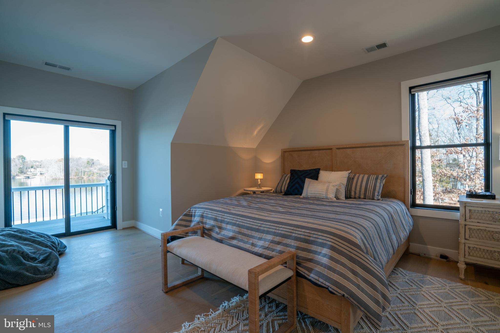 290 Carrs Bridge Road Mineral, VA 23117 - Photo 35 of 101 a bedroom with a bed a balcony a bed and a large window