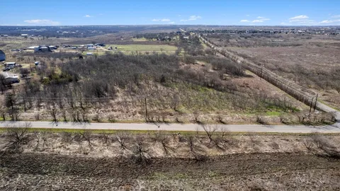 a view of a yard with wooden fence