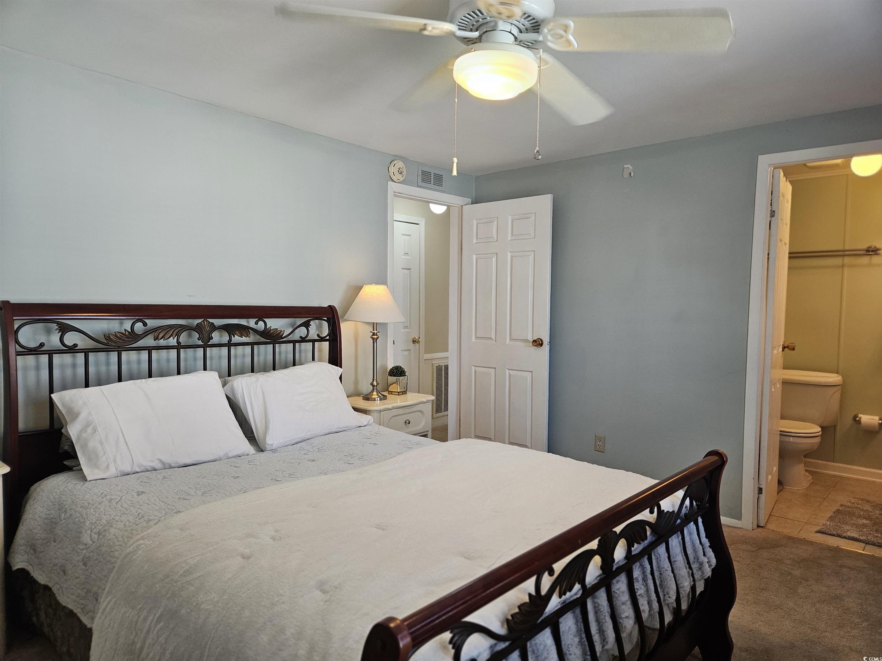 471 Meadowlark Surfside Beach, SC 29575 - Photo 18 of 40 Bedroom with ceiling fan, carpet floors, and ensuite bath