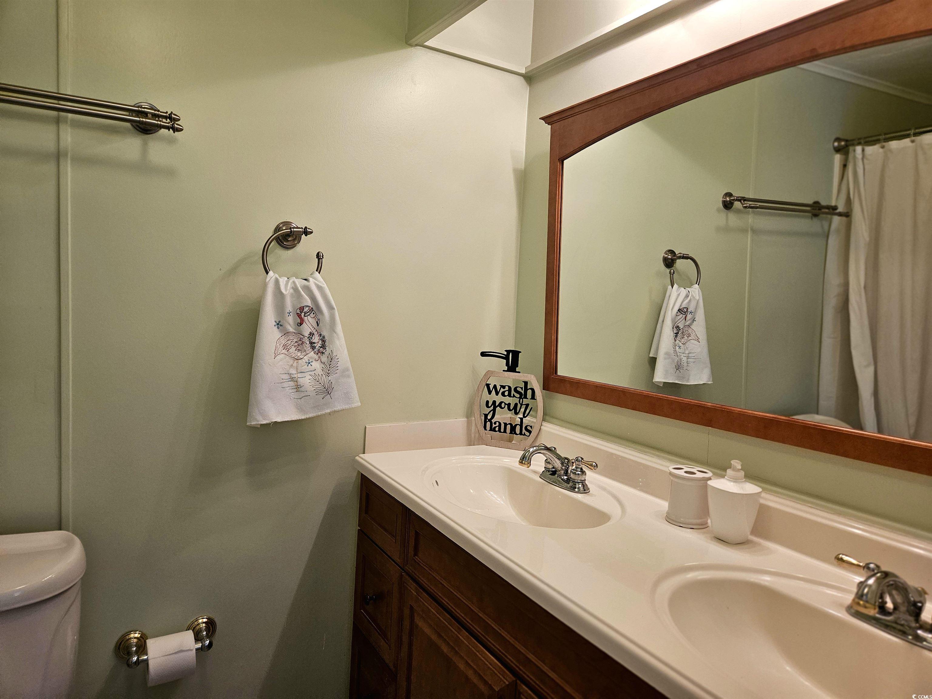 471 Meadowlark Surfside Beach, SC 29575 - Photo 19 of 40 Full bath featuring double vanity, crown molding, and a shower with shower curtain