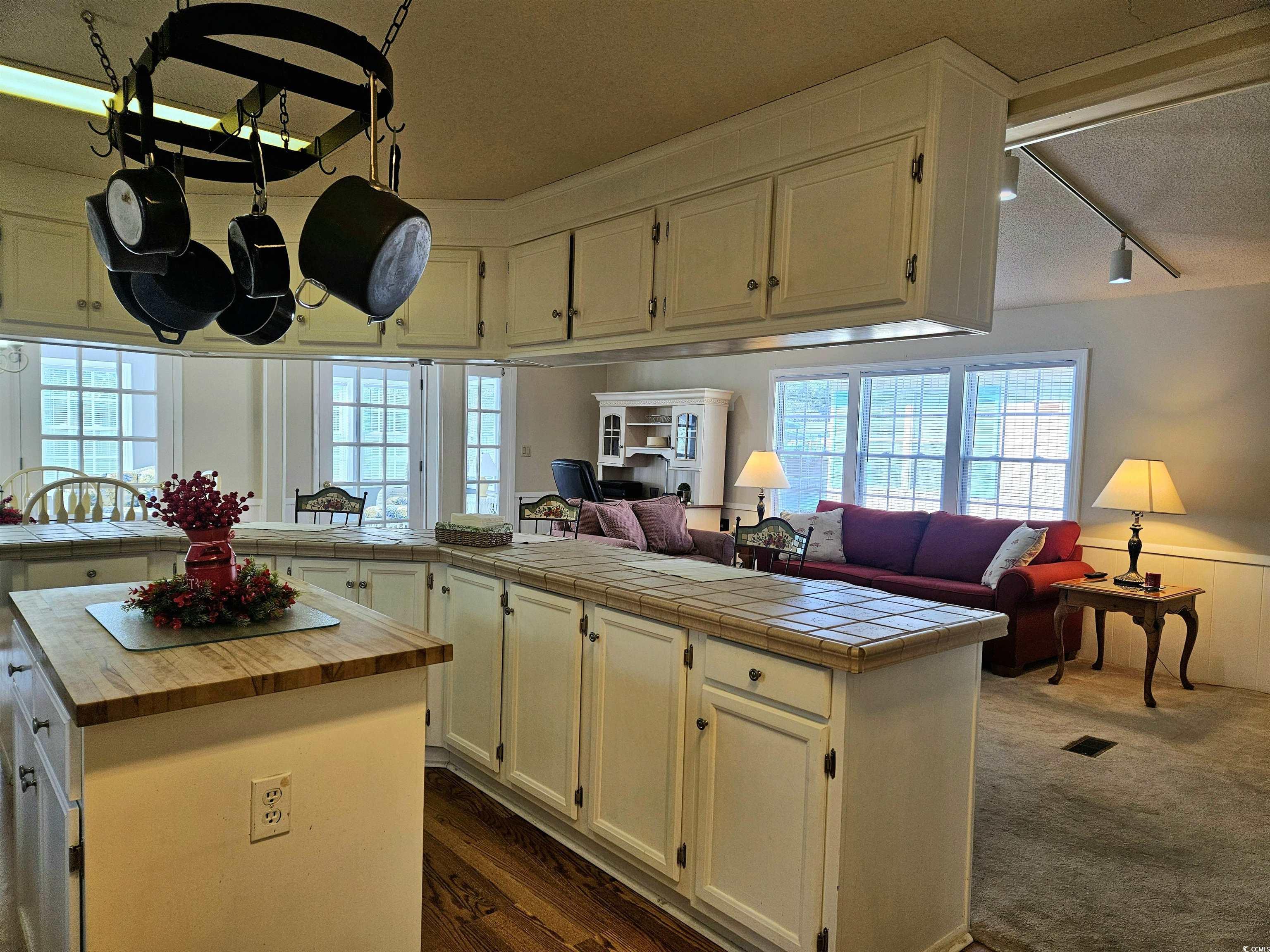 471 Meadowlark Surfside Beach, SC 29575 - Photo 40 of 40 Kitchen with open floor plan, tile countertops, track lighting, a textured ceiling, and white cabinetry