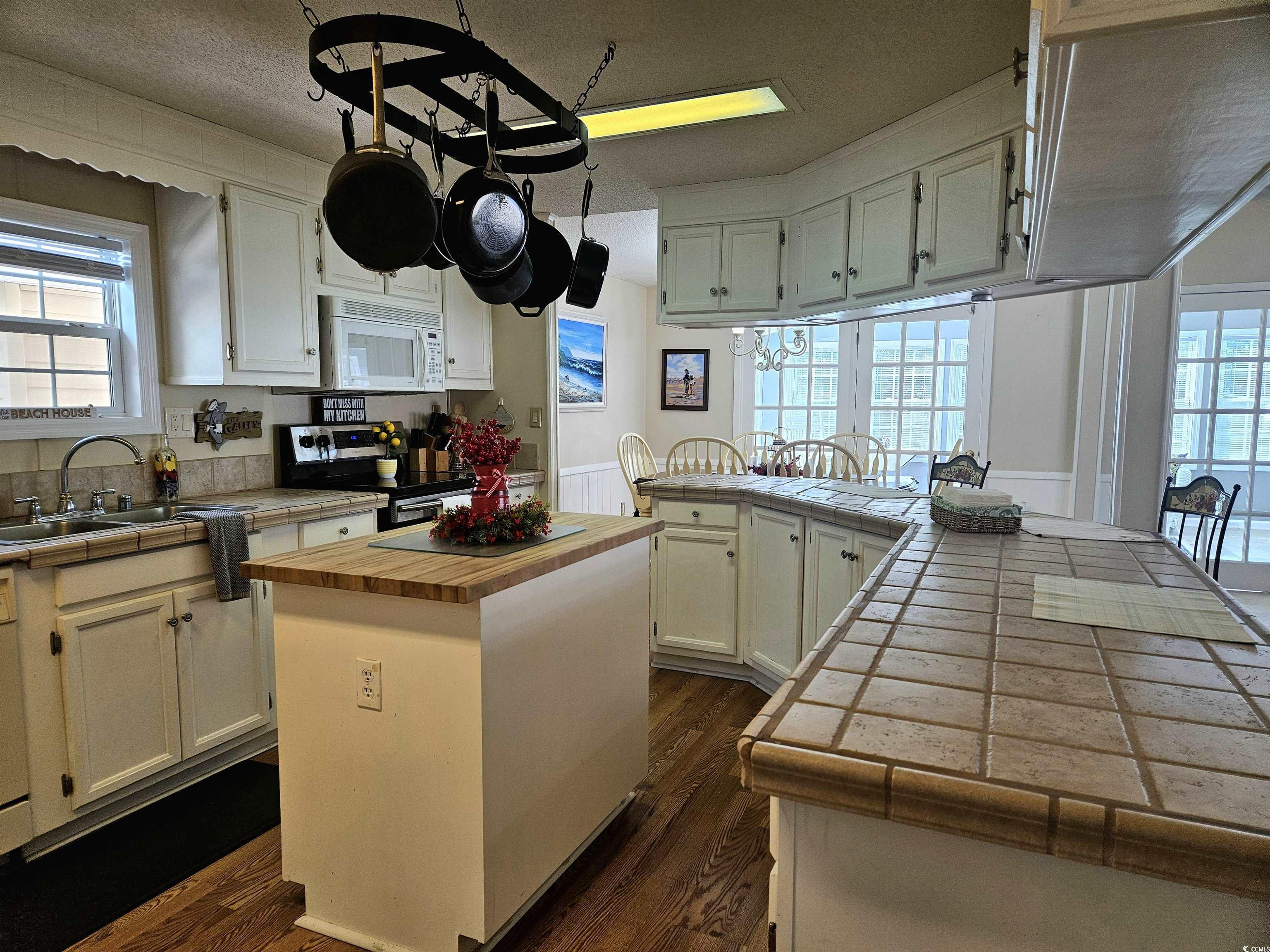 471 Meadowlark Surfside Beach, SC 29575 - Photo 2 of 40 Kitchen featuring tile countertops, stainless steel electric range oven, a peninsula, a center island, and white cabinetry