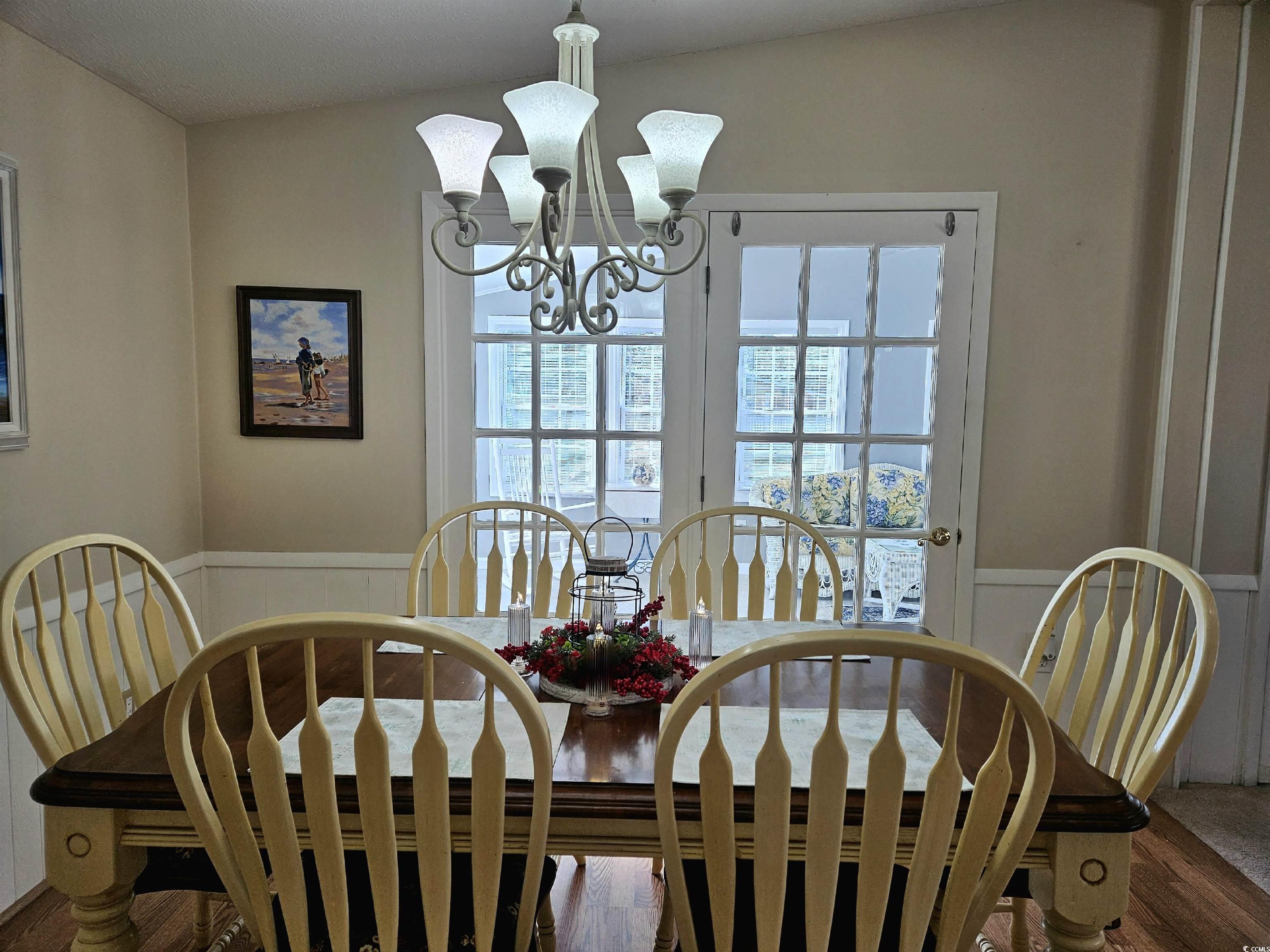 471 Meadowlark Surfside Beach, SC 29575 - Photo 3 of 40 Dining area featuring wainscoting, a chandelier, and wood finished floors