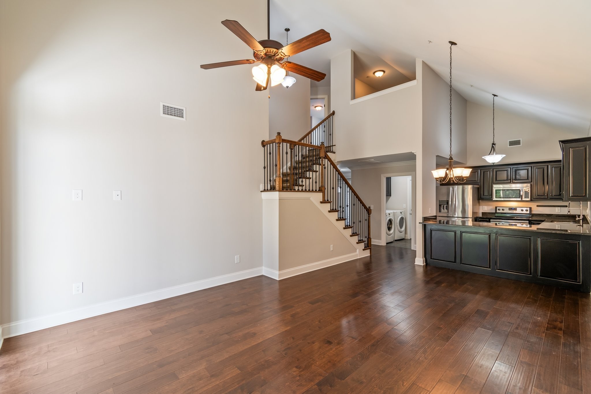 1041 Irish Way Spring Hill, TN 37174 - Photo 11 of 38 a view of a kitchen with wooden floor and a ceiling fan