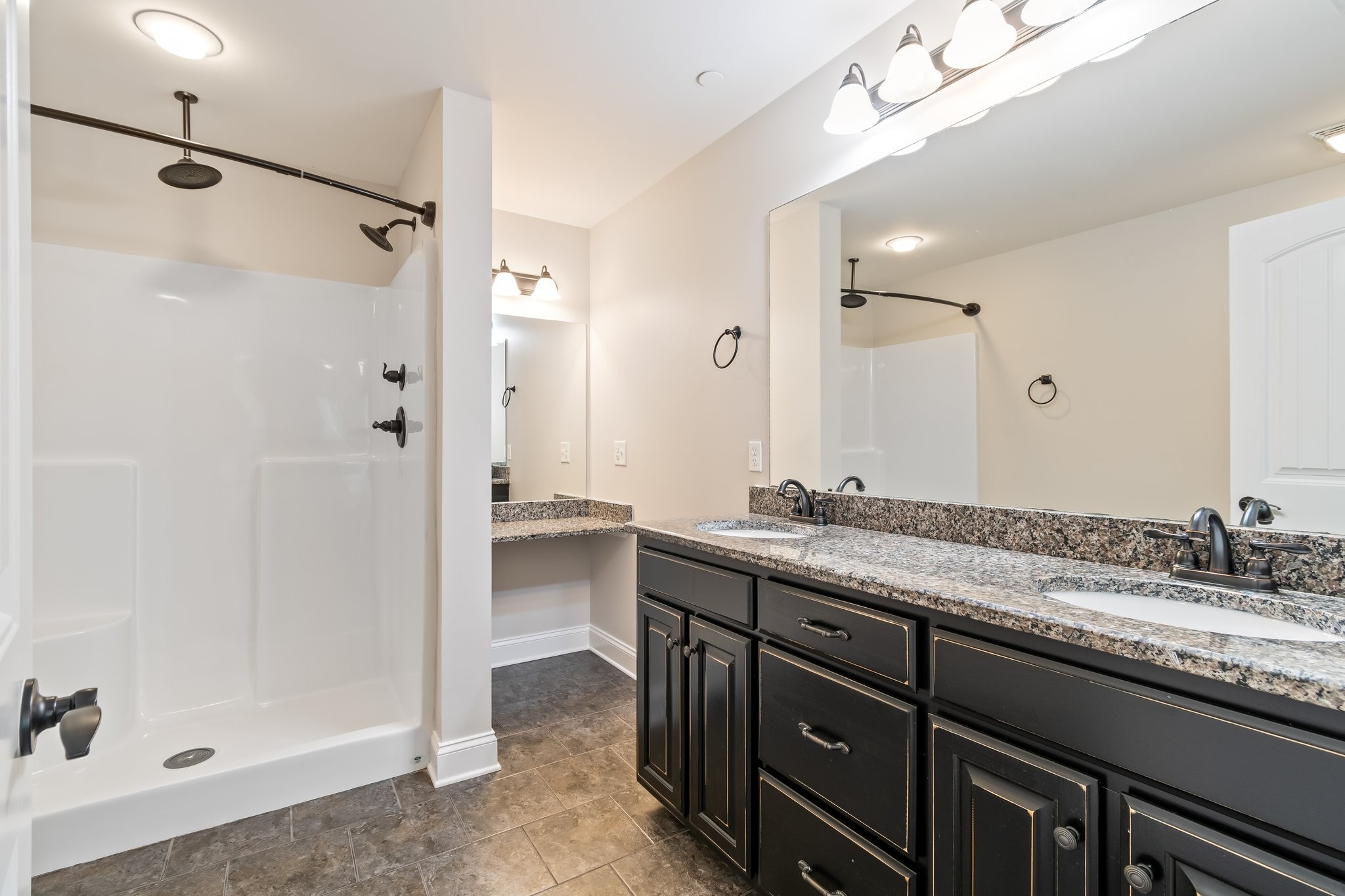 1041 Irish Way Spring Hill, TN 37174 - Photo 18 of 38 a bathroom with a granite countertop sink a mirror a shower and a bathtub
