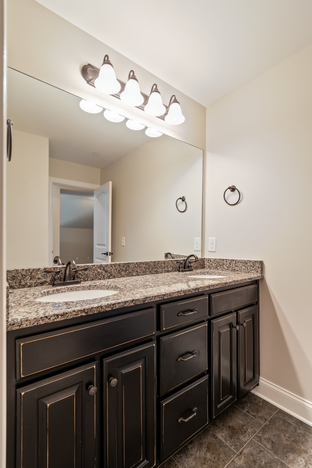 1041 Irish Way Spring Hill, TN 37174 - Photo 31 of 38 a bathroom with a granite countertop sink and a mirror