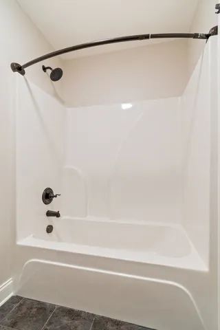 a bathroom with a shower and a bath tub