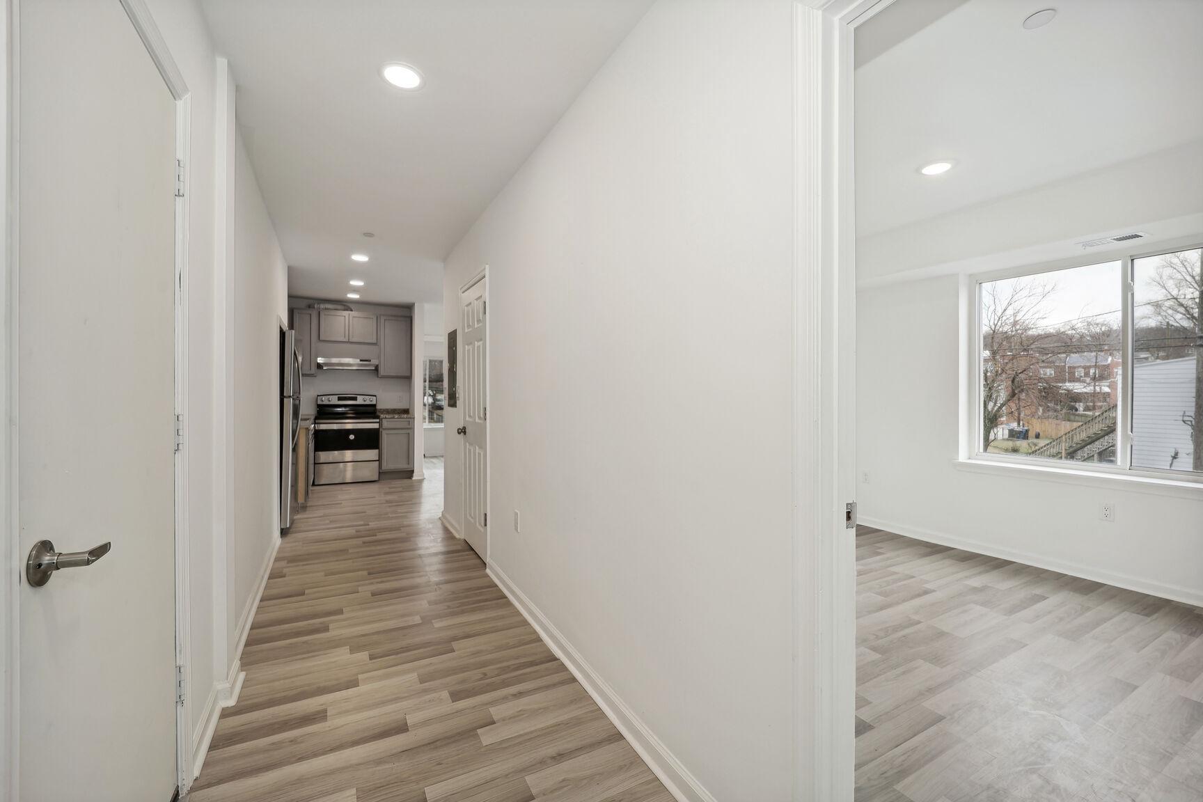 1642 16th Street Southeast, Unit 3 Washington, DC 20020 - Photo 1 of 22 a view of a hallway with wooden floor and staircase