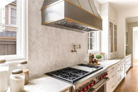 a kitchen with a stove and a window