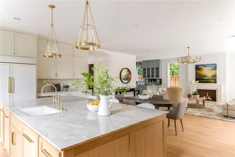 a kitchen with a table chairs and white cabinets