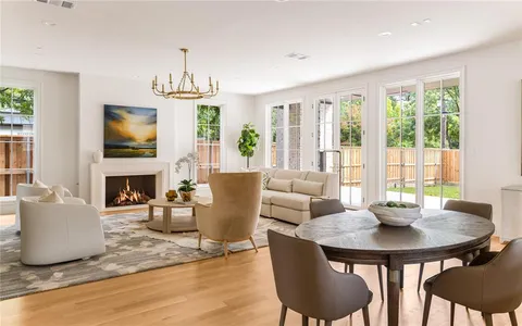 a living room with fireplace furniture and a table