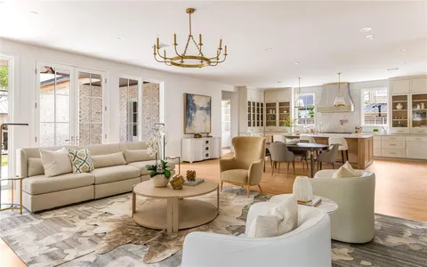 a living room with furniture or chandelier and a dining table