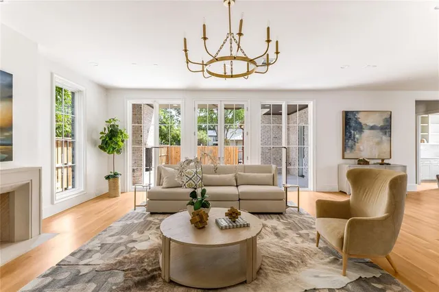 a living room with furniture a flat screen tv and a large window
