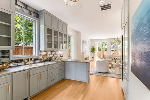 a large white kitchen with a large window