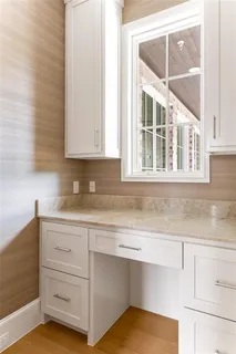 a kitchen with granite countertop white cabinets and a sink