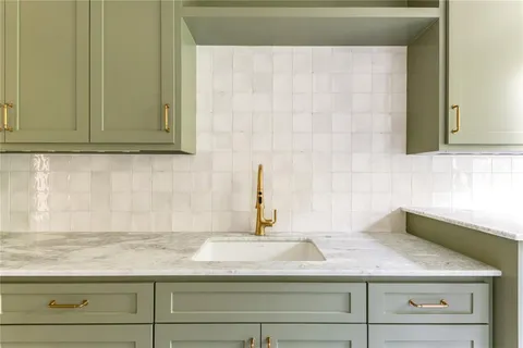 a sink with a granite countertop white sink and vanity
