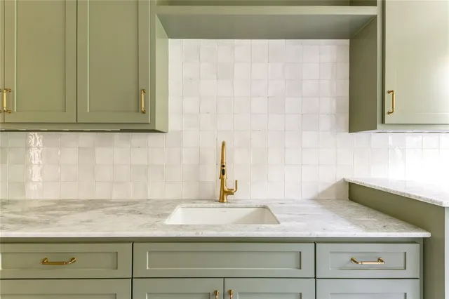 a sink with a granite countertop white sink and vanity