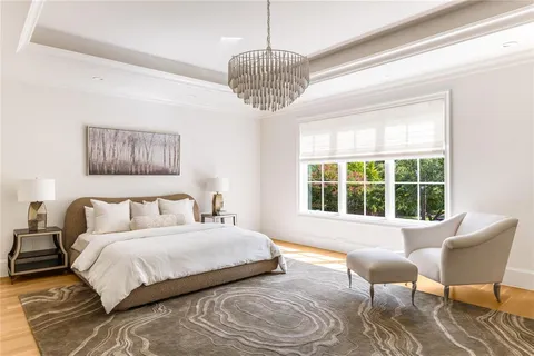 a bedroom with a bed and a chair