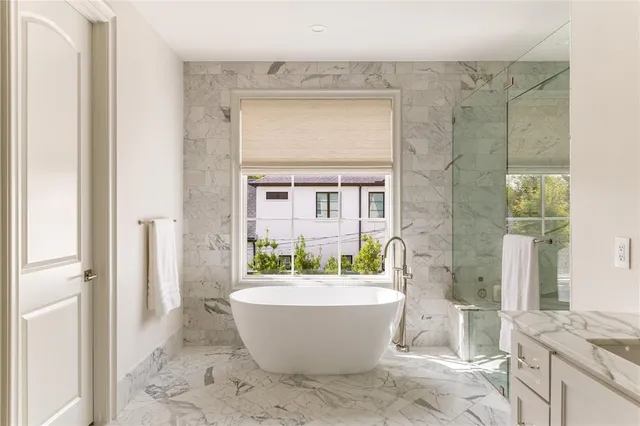 a spacious bathroom with a bathtub and shower