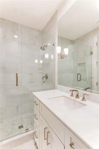 a bathroom with a shower sink and mirror