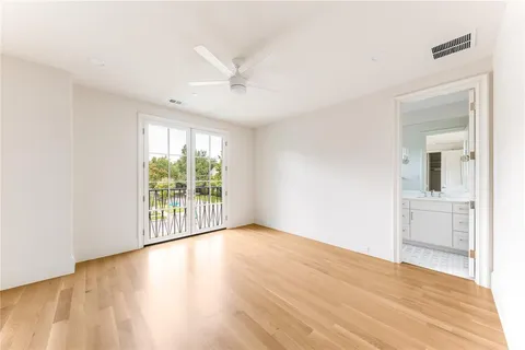 a view of a livingroom with wooden floor and a large window
